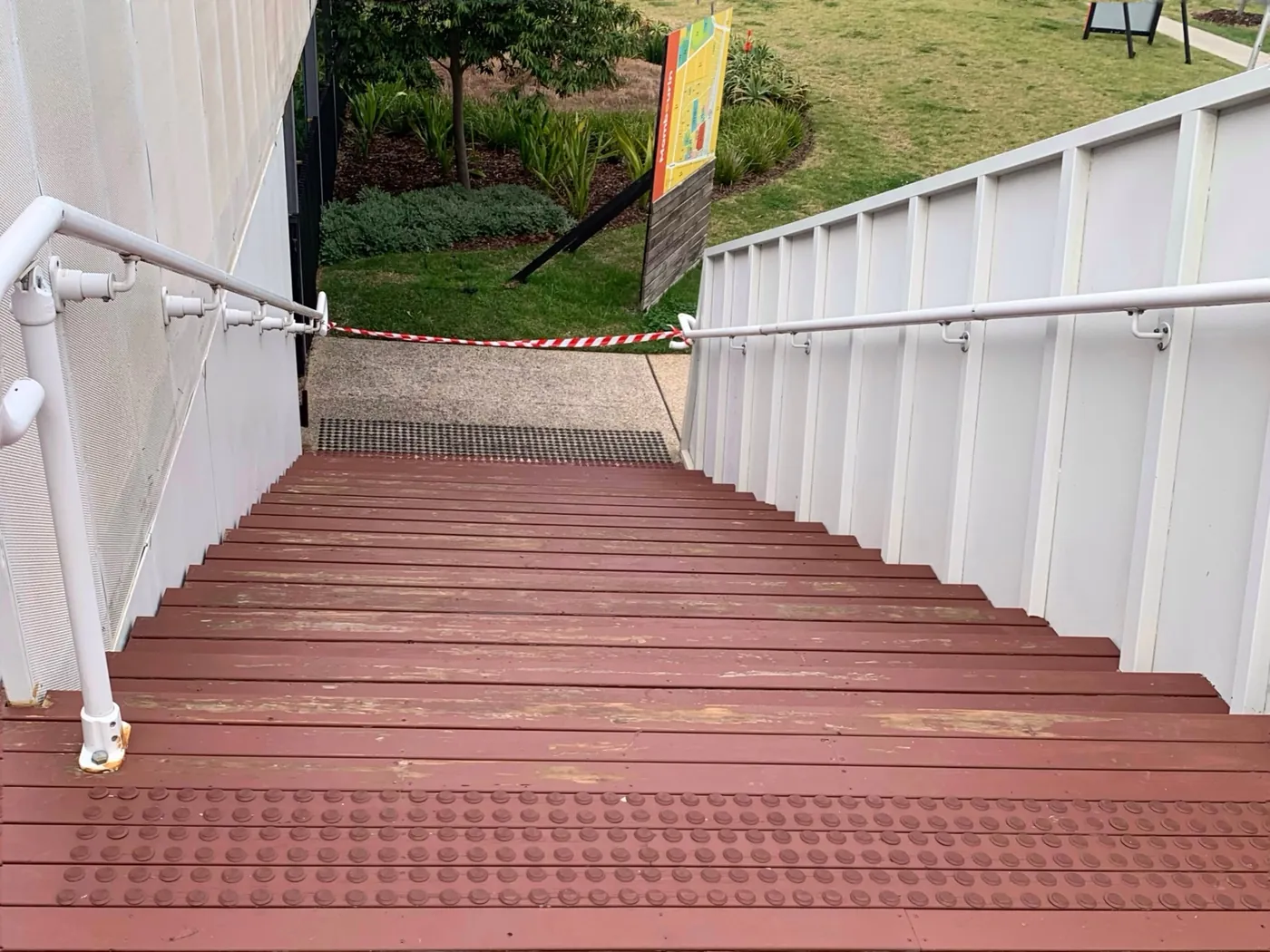 External stairs before, red treads worn back to bare timber, Point Cook