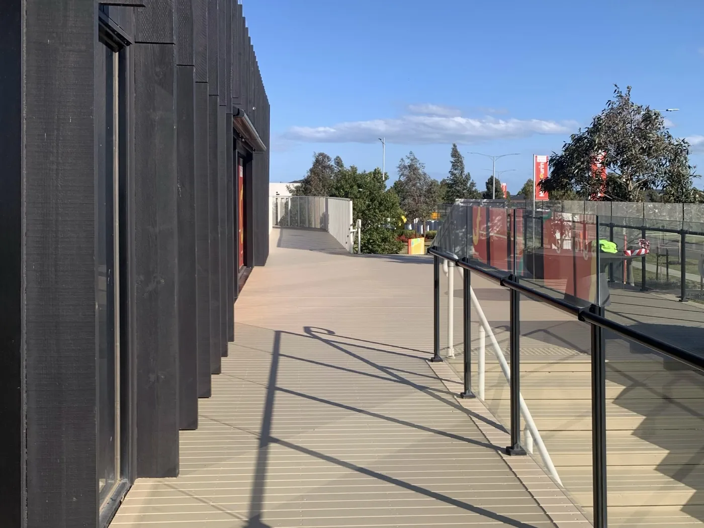 Same walkway after, sand coloured decking in full sun, Point Cook
