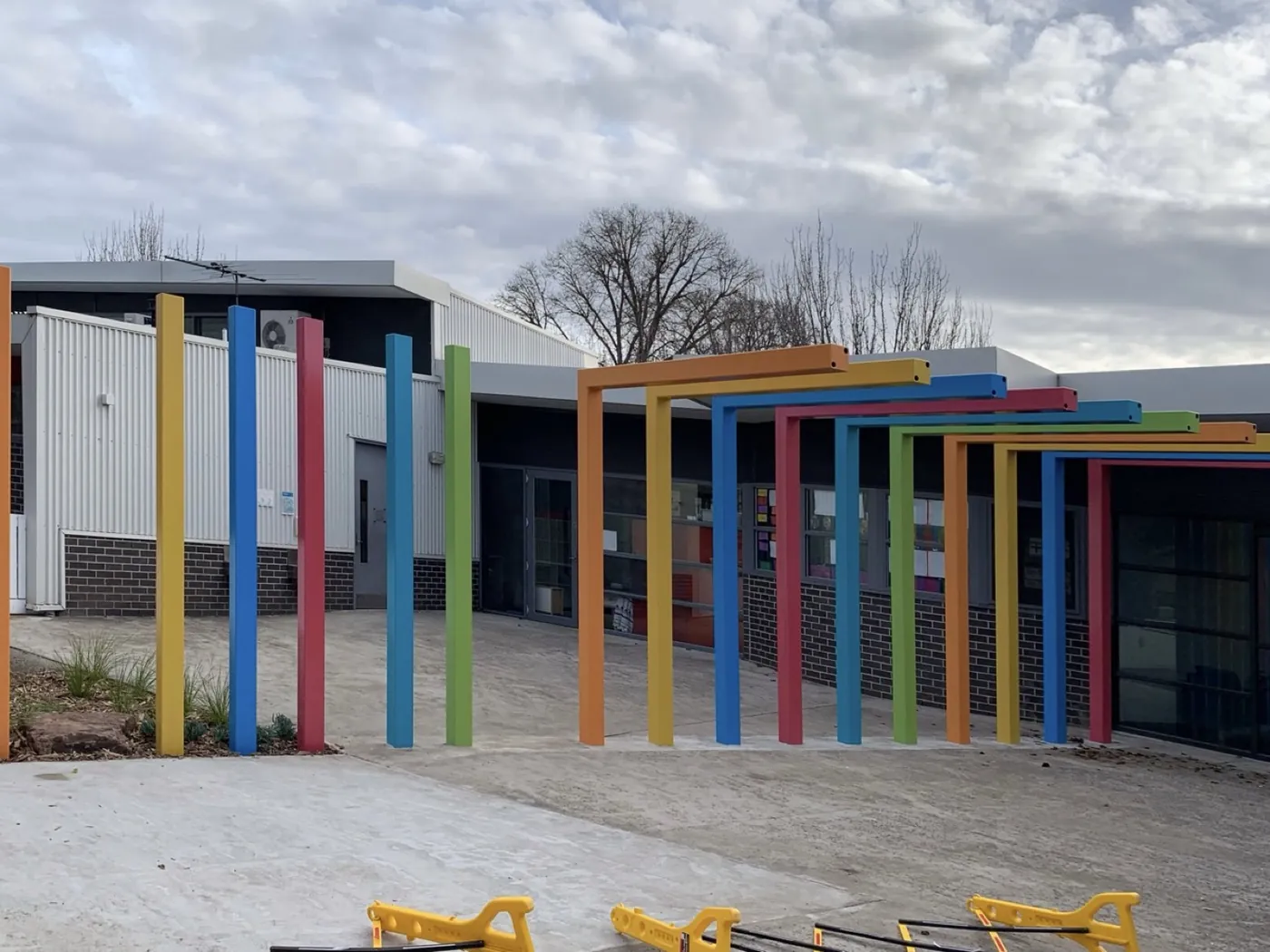 Same colonnade after, painted in bright colours, Essendon