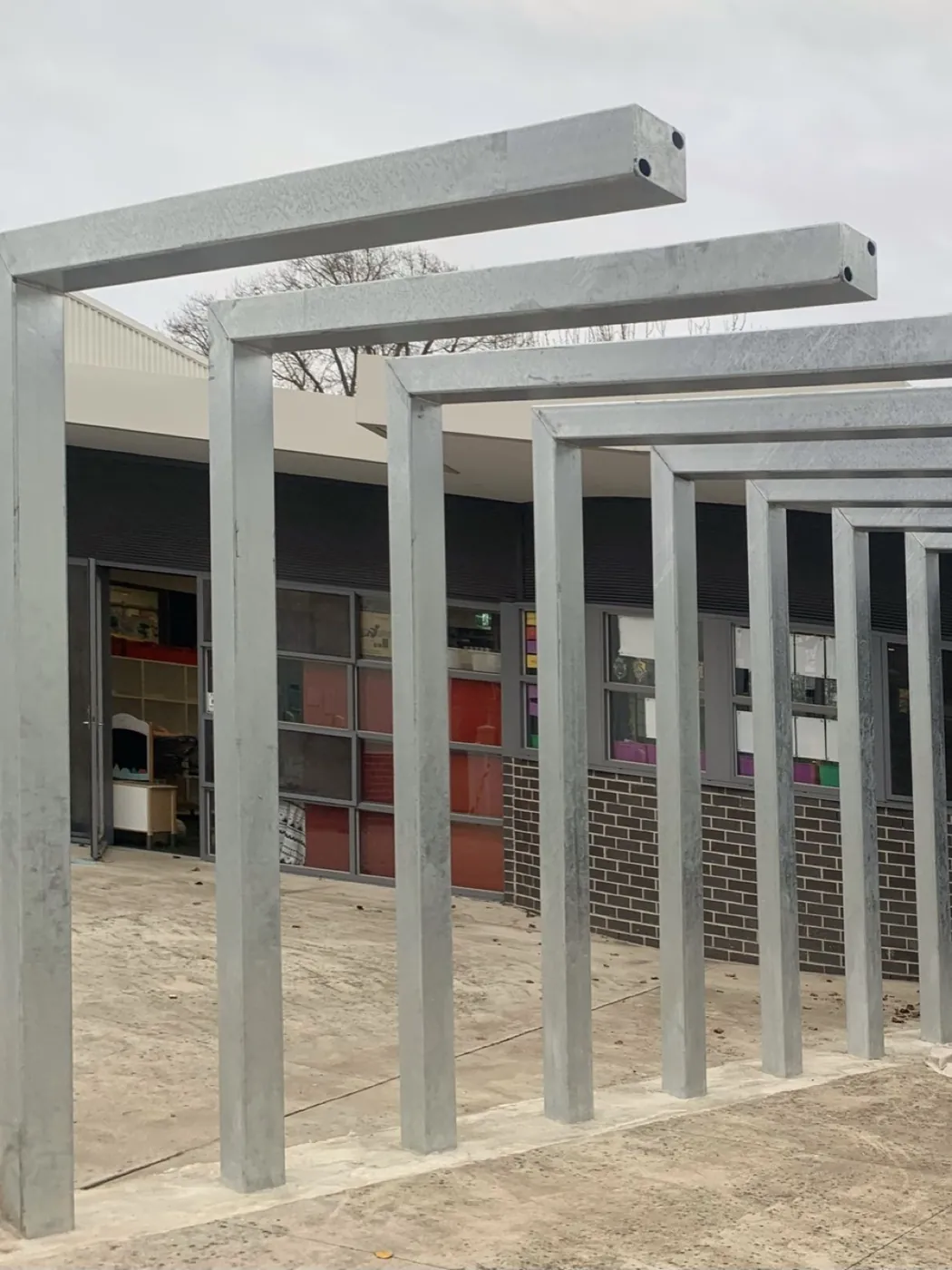 Colonnade from the opposite end before, grey steel, Essendon