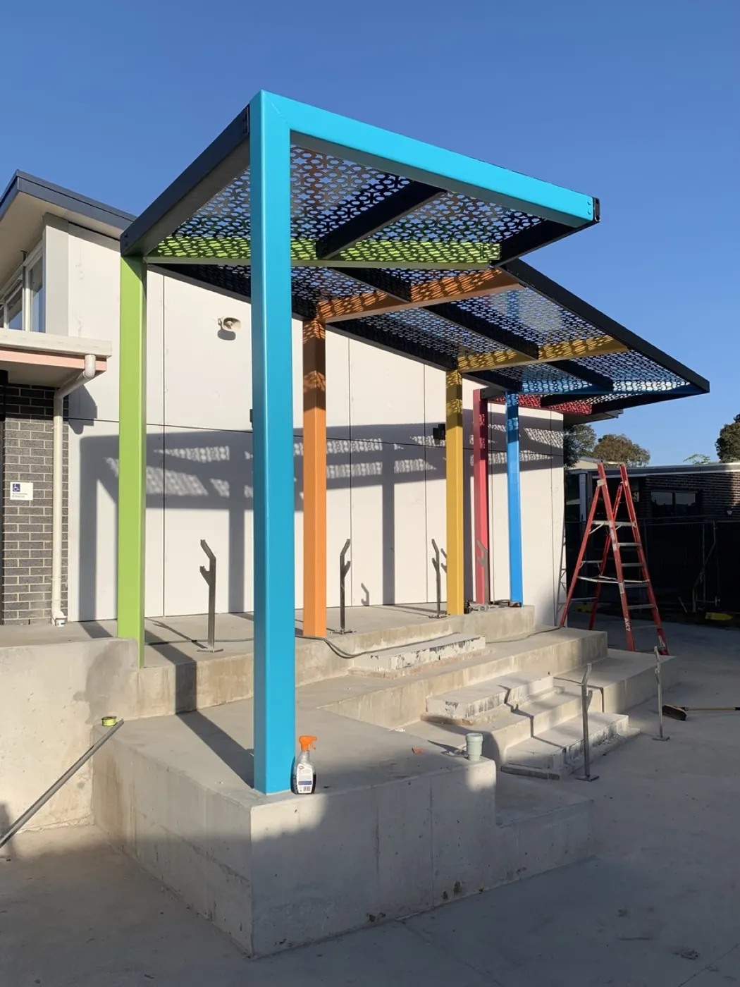 Finished canopy close up, teal beam and perforated roof, Essendon