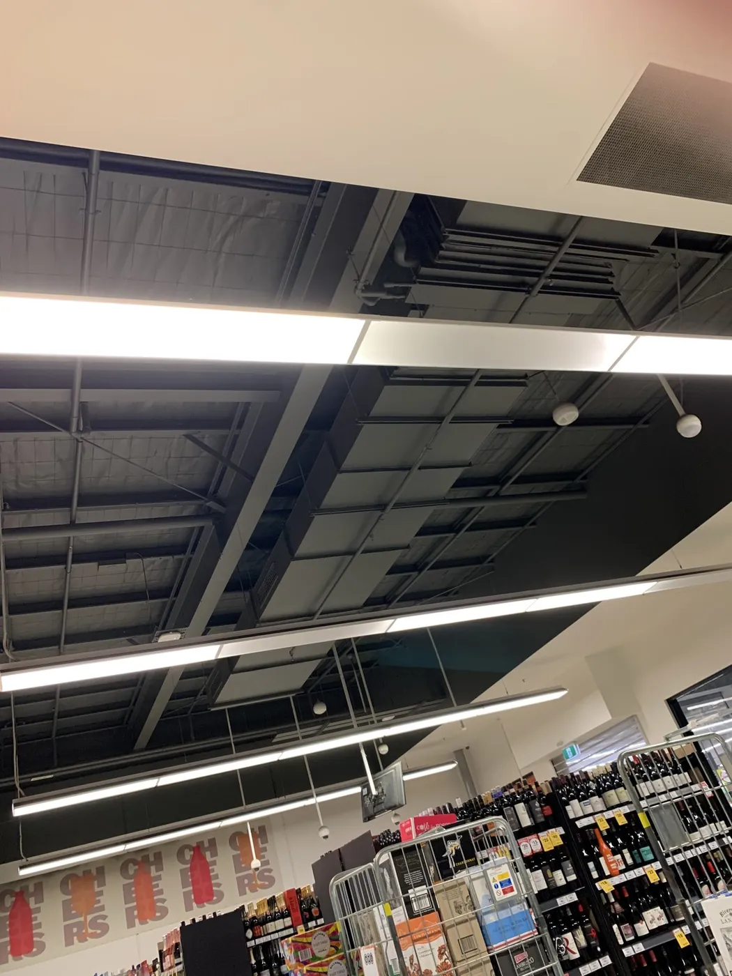 Close up of the finished ceiling, black structure and services behind the linear lights, Ballarat