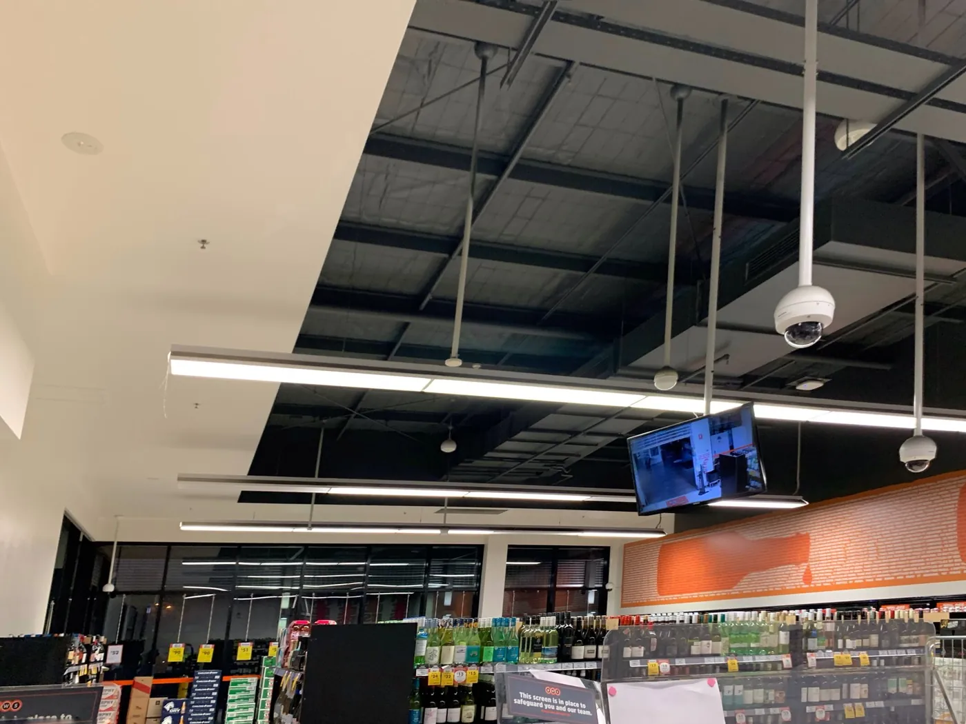 Black ceiling above the orange feature wall and the shopfront glazing, Ballarat