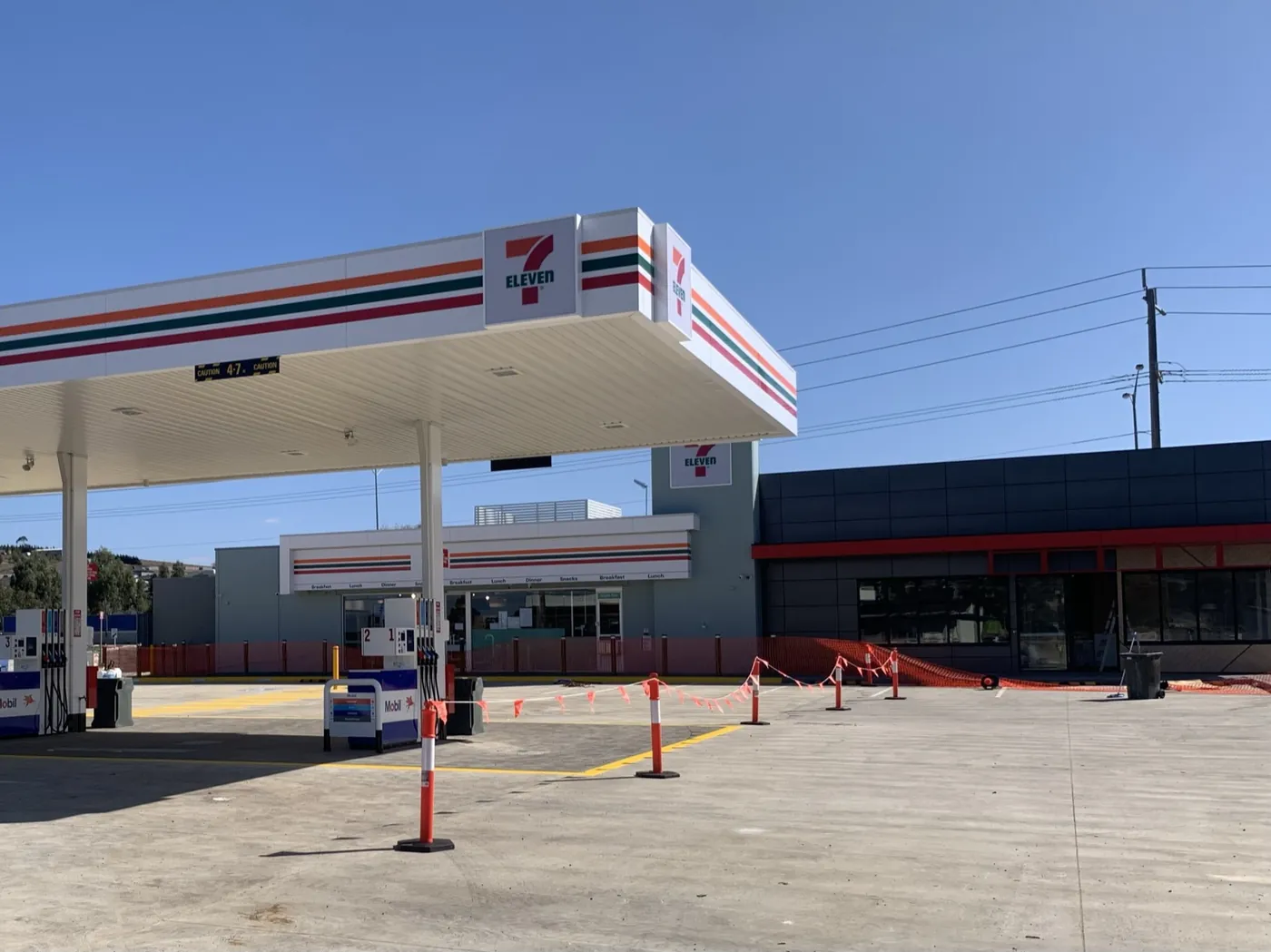 7-Eleven and Mobil fuel canopy with brand signage, Sunbury