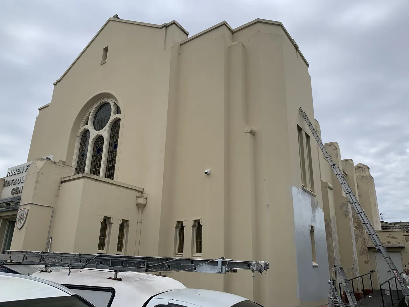 Side elevation part way through, patched render over the old cream, Caulfield
