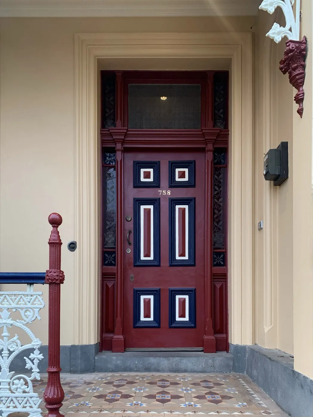 Panelled front door of a Victorian terrace, repainted with the mouldings kept sharp