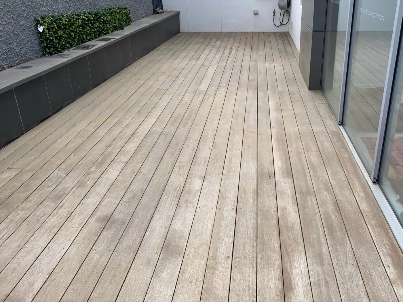 Rooftop timber deck in Alphington before, weathered grey and bare
