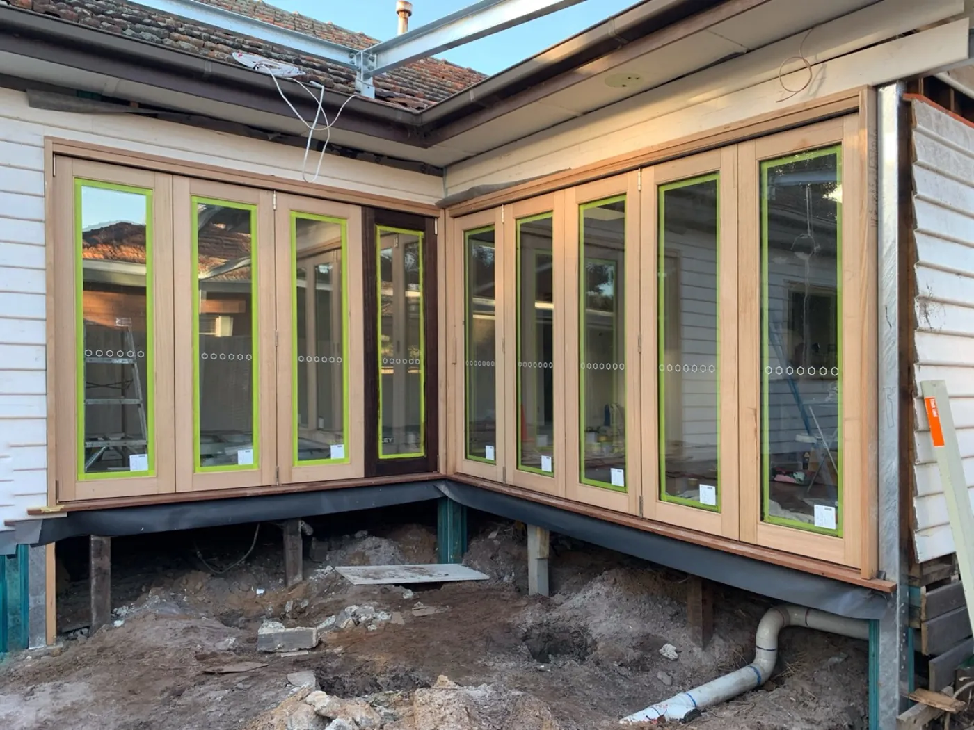 Cedar bifold frames in Brighton before, timber weathered and dulled
