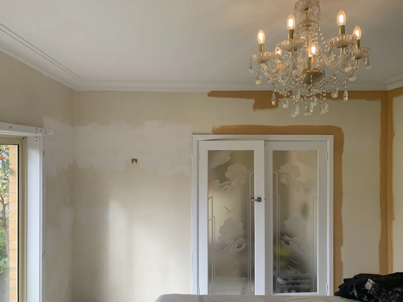 Lounge part way through, apricot cut in along the cornice while the wall below is still pale cream, Oakleigh
