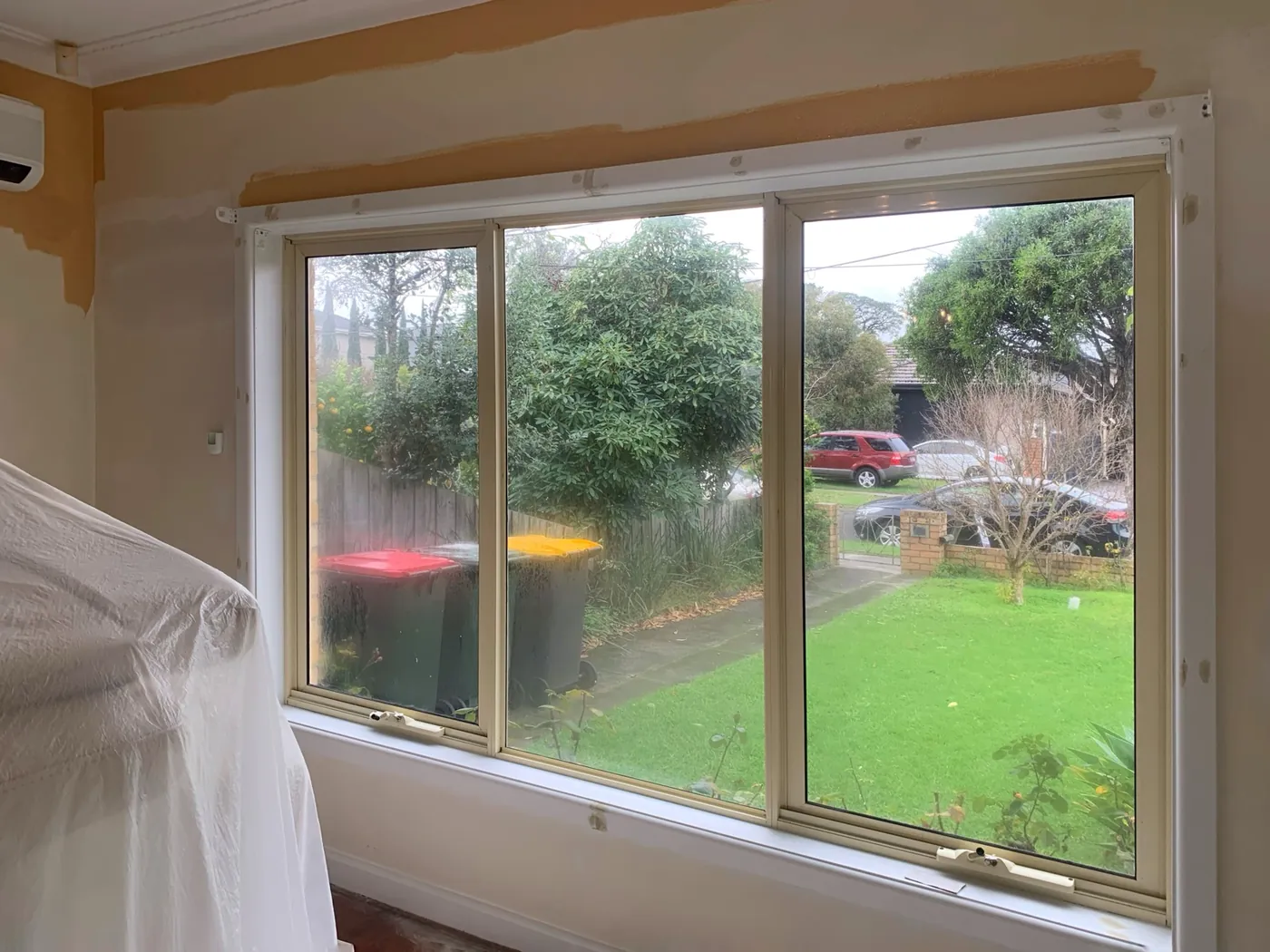 Close up of the cut in line, fresh apricot meeting the old cream in a straight edge above the window, Oakleigh