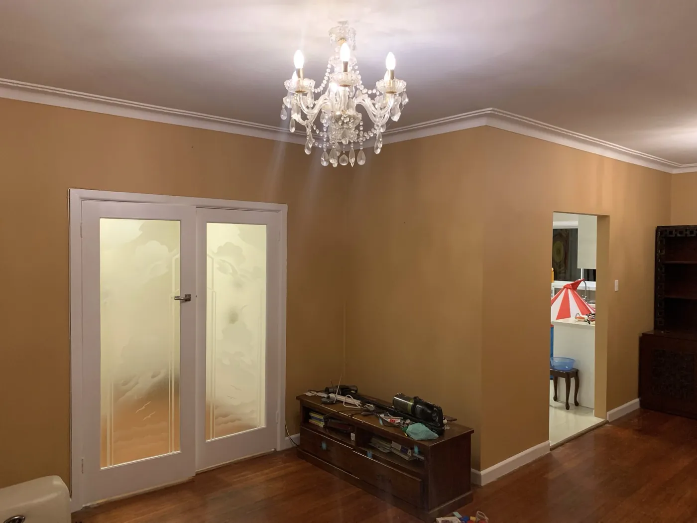 Dining room in an older Oakleigh home in warm apricot with white cornices