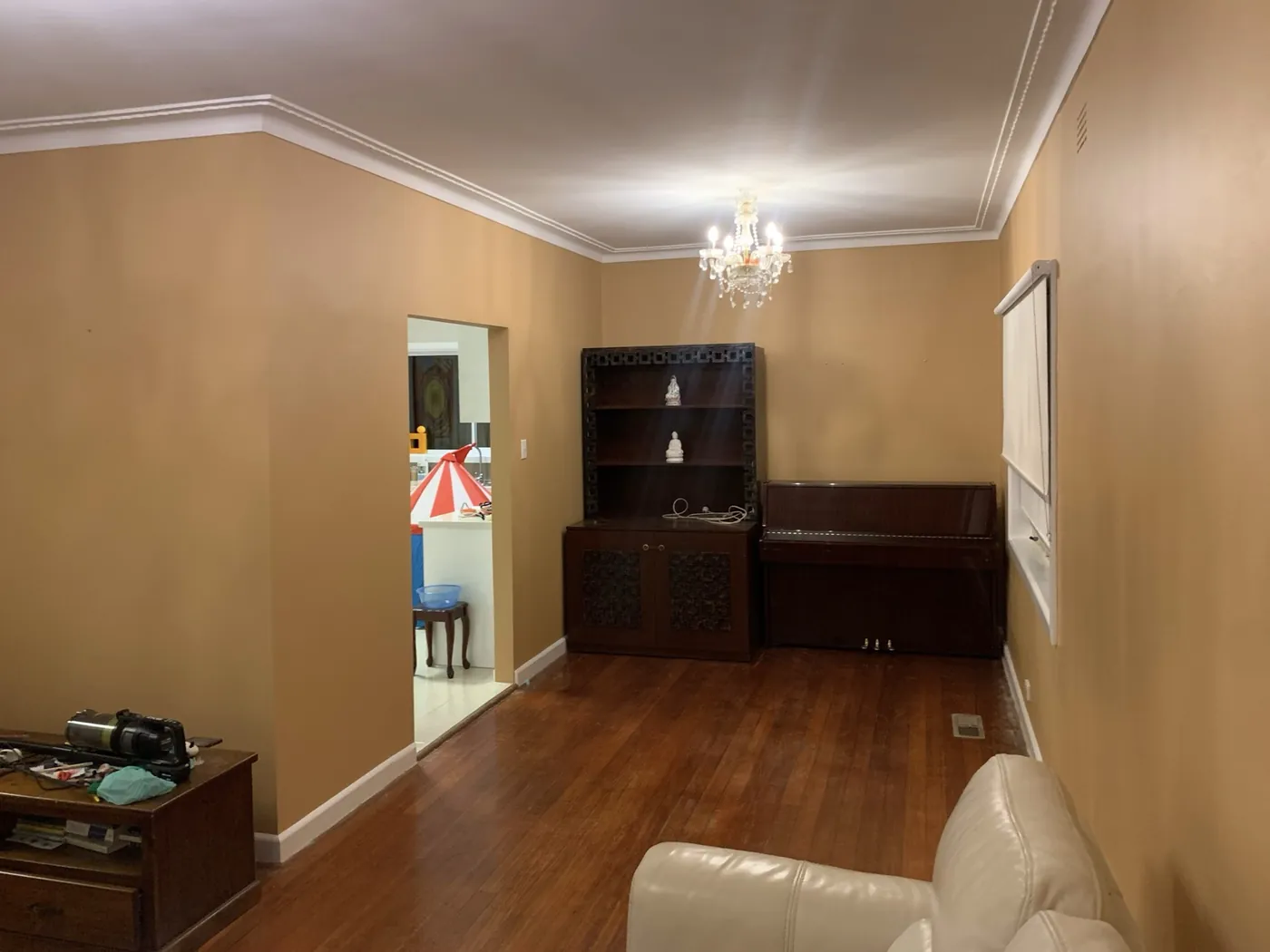 Finished living area in warm apricot looking through to the next room, cornices and skirtings in white, Oakleigh
