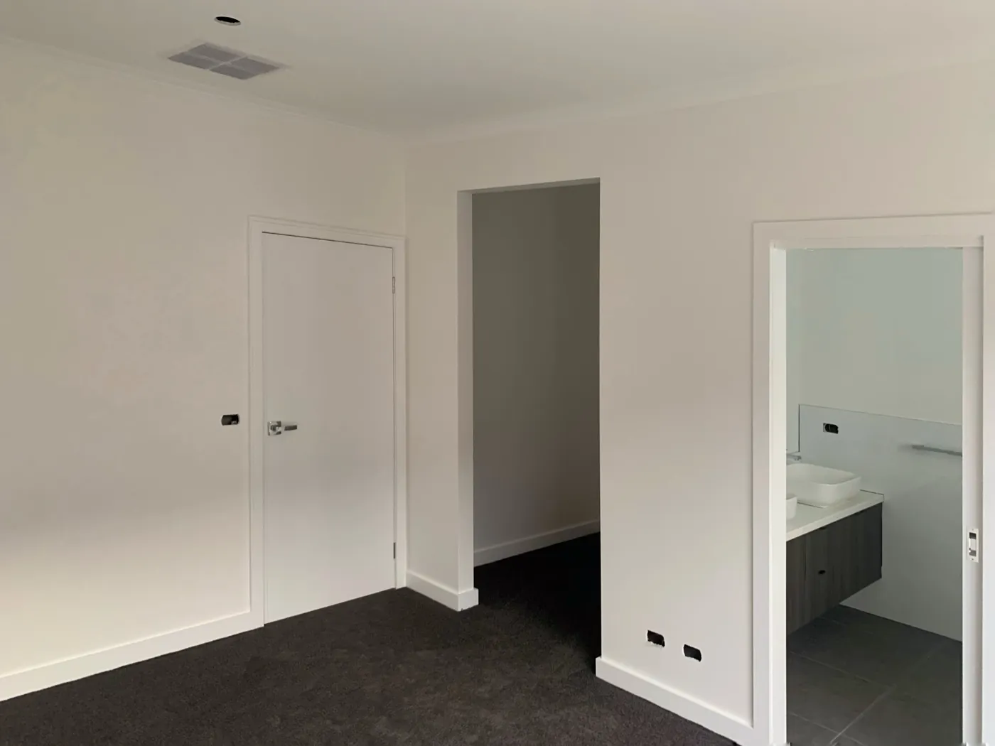 Bedroom in a new home with an ensuite doorway, painted door, architraves and skirtings, Melton