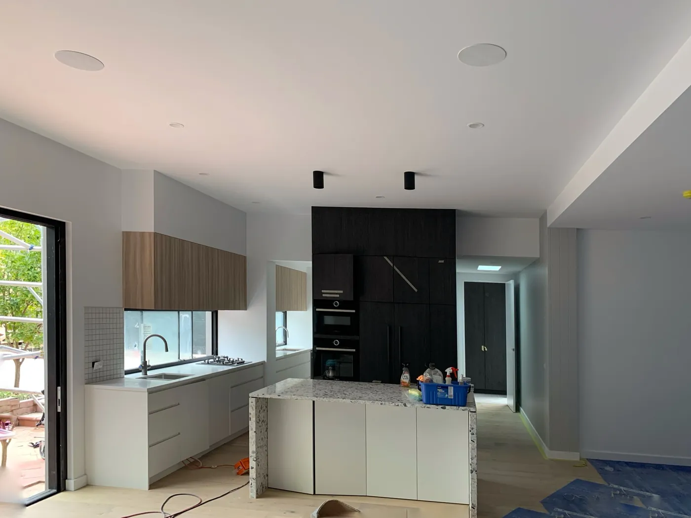 Open plan kitchen and living repainted in off white with soft grey walls