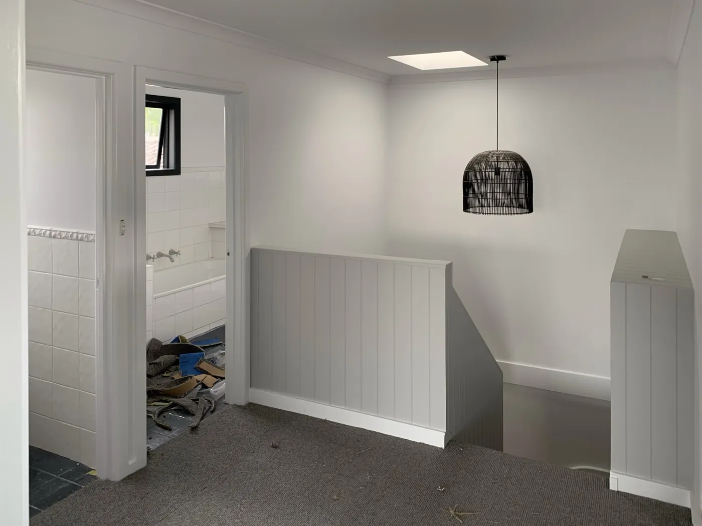Upstairs landing repainted with panelling in soft grey against white walls