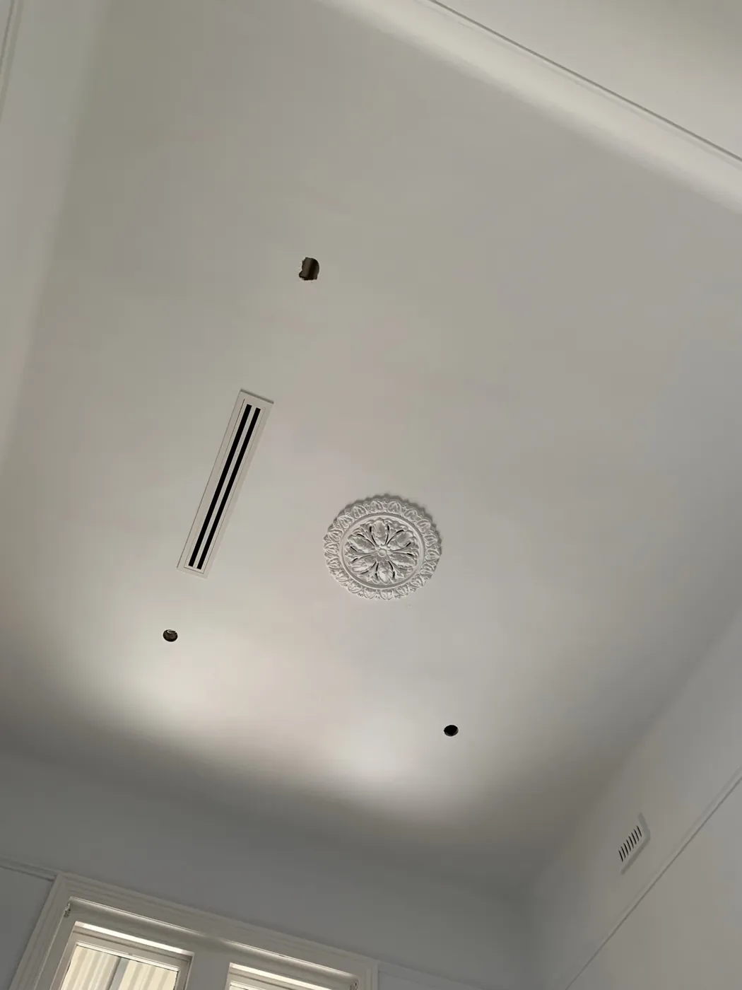 The same ceiling rose finished in an even off white with no trace of the repairs, Armadale
