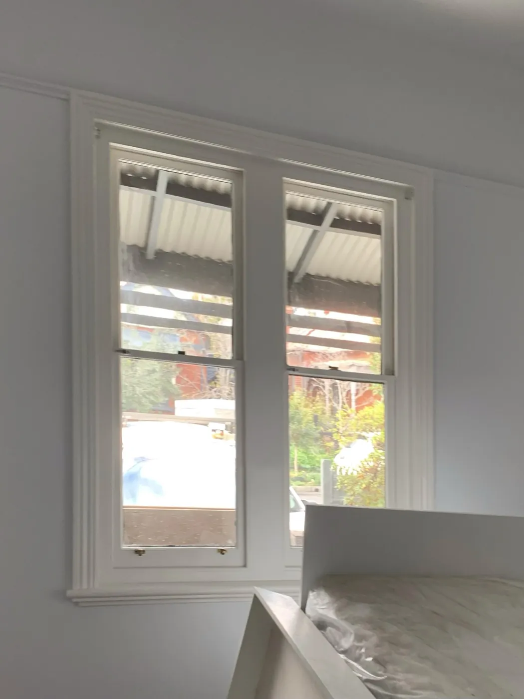 The same window finished, sashes and architraves in crisp white against clean off white walls, Armadale