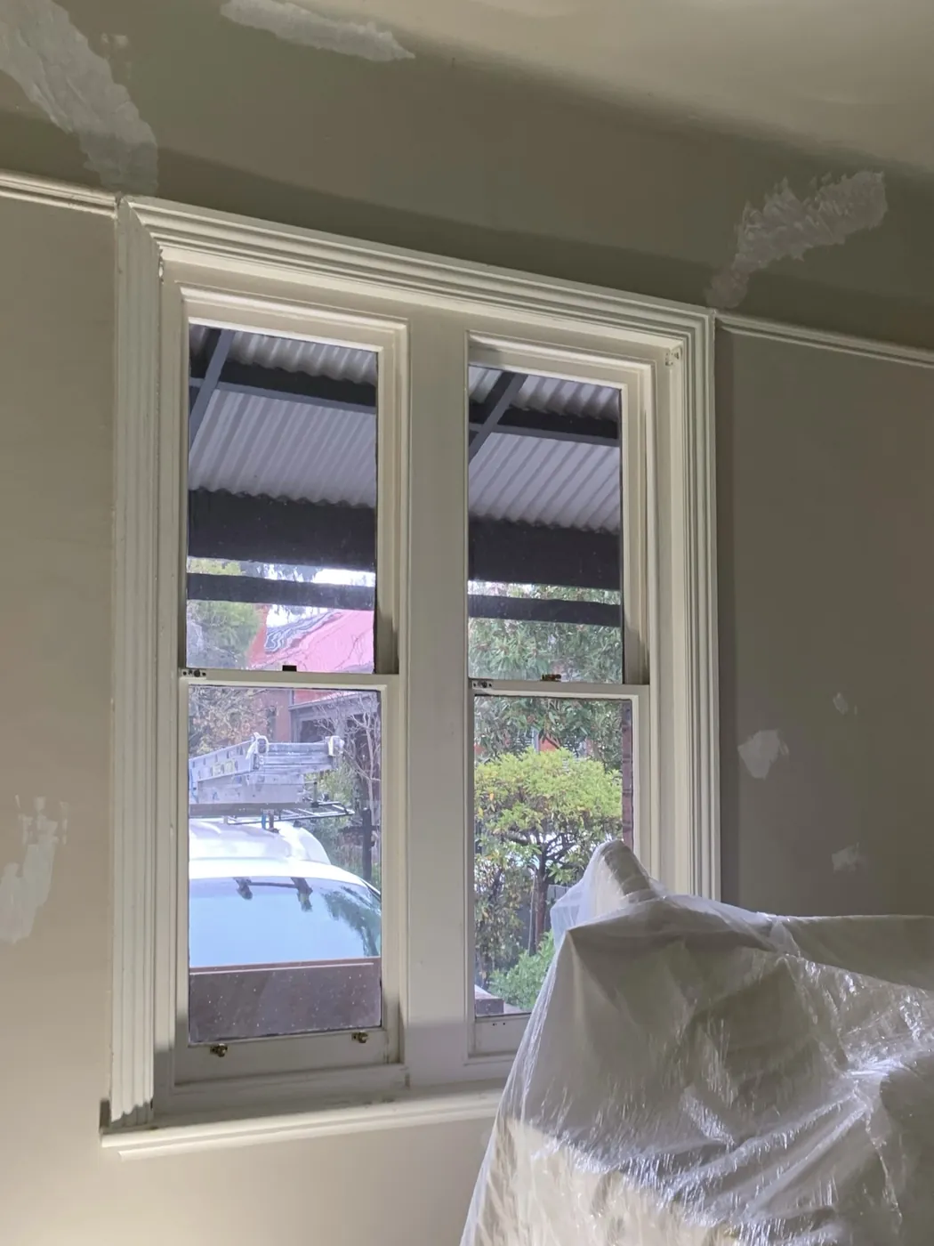 Second bedroom before, patched wall and ceiling beside the twin sash window, Armadale