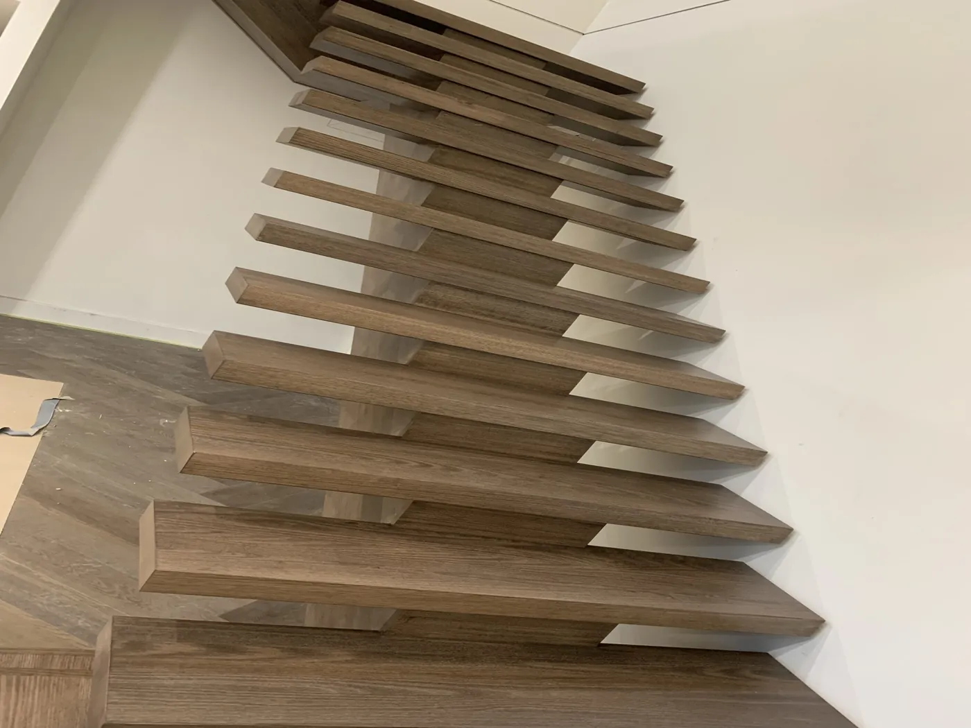 Same open treads after staining, deep brown timber against a white wall, Doncaster