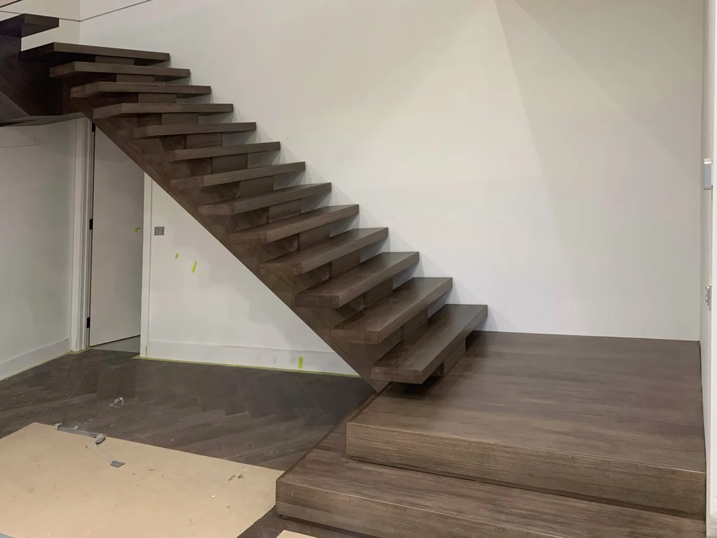 Same staircase after, treads stained a deep smoky brown with a clear sealed finish, Doncaster