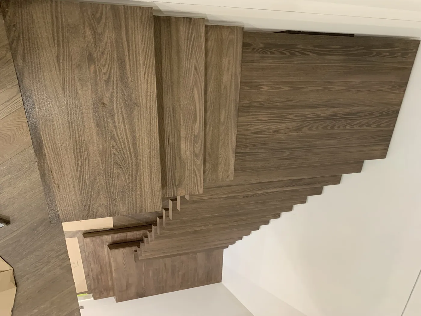 Looking down the same flight after, every tread in an even stained finish, Doncaster