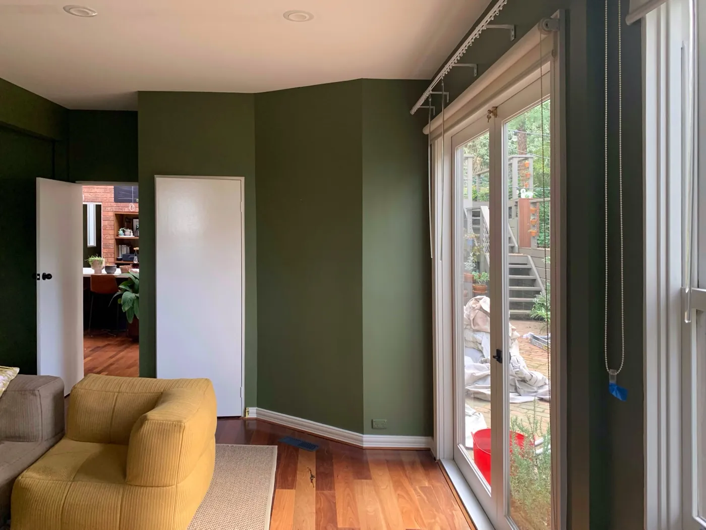 Same living area in deep olive, white doors and architraves against the garden doors, Ferntree Gully