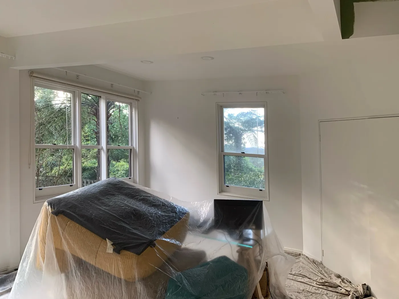 Study before, white walls and ceiling beam with furniture under plastic, Ferntree Gully