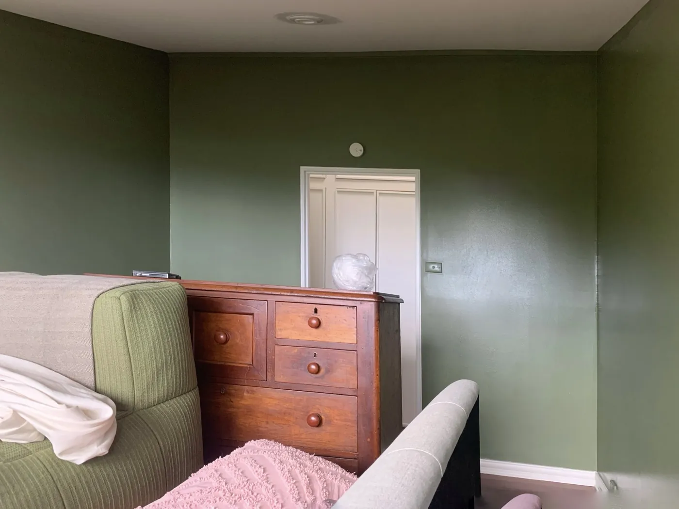 Same bedroom in deep olive, the panelled door and skirtings cut in white, Ferntree Gully